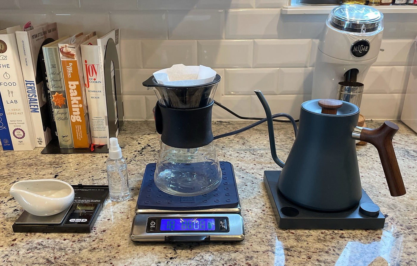 A coffee pour-over setup with a kettle and scale.