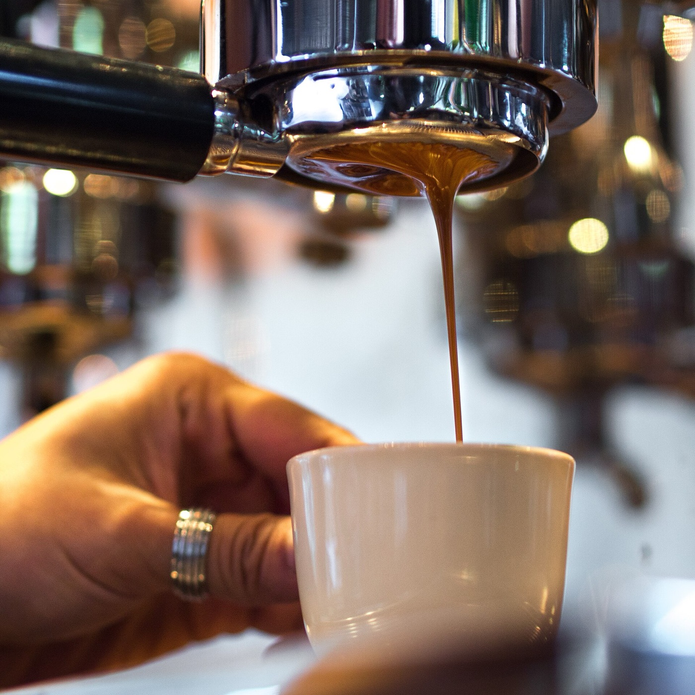 A naked portafilter prepared for an espresso dose.