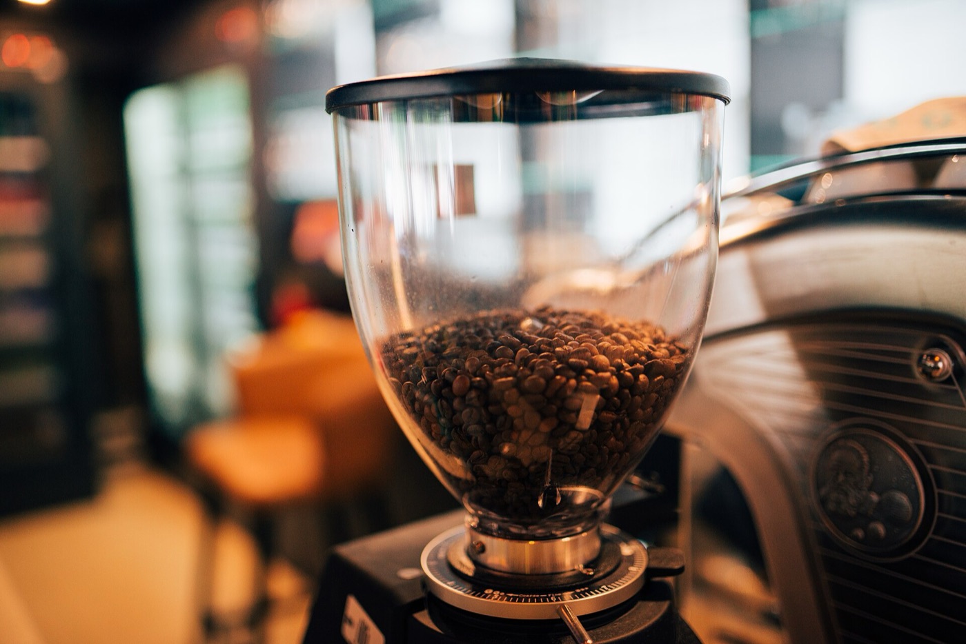 A coffee grinder with freshly roasted beans in an artisan cafe.