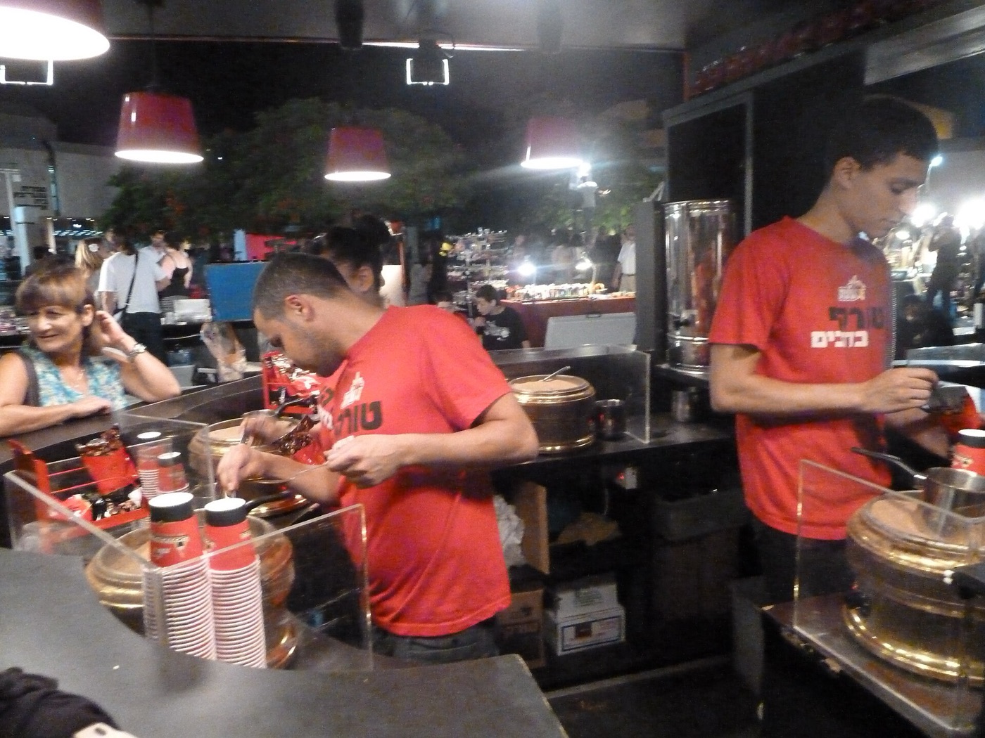 A cup of black coffee served in a public square.